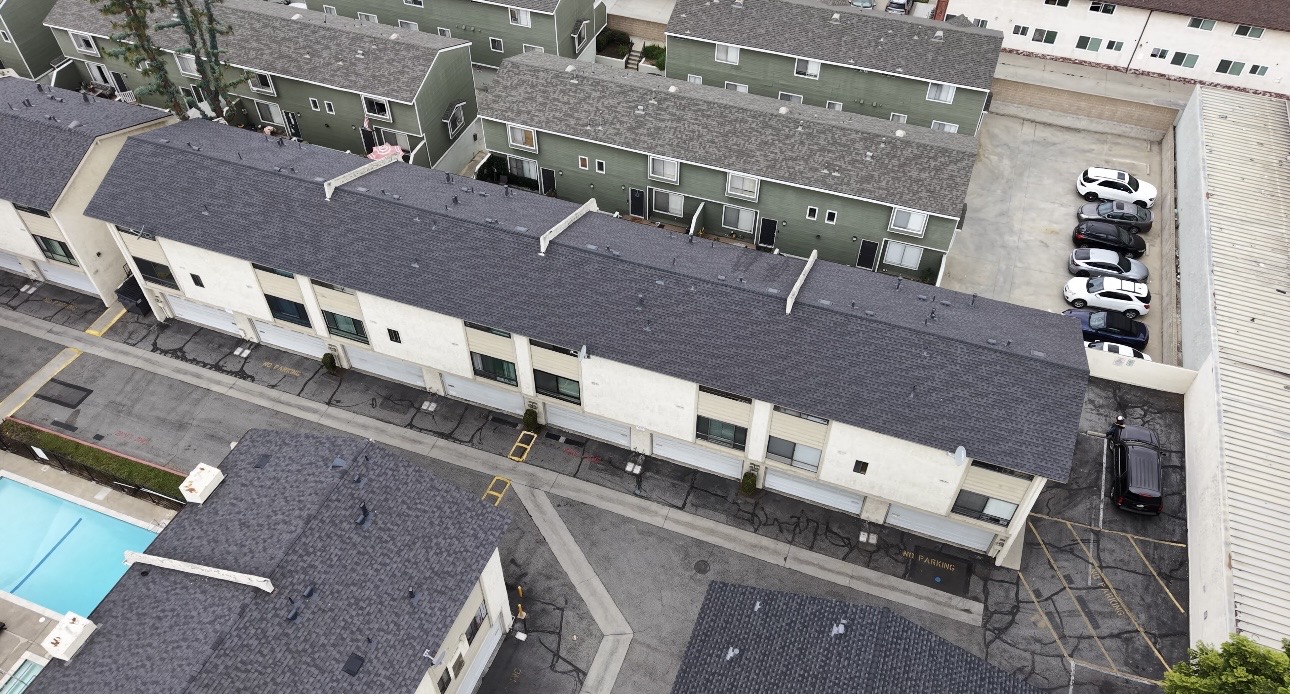 Aerial overview of completed shingle roofs on a residential complex